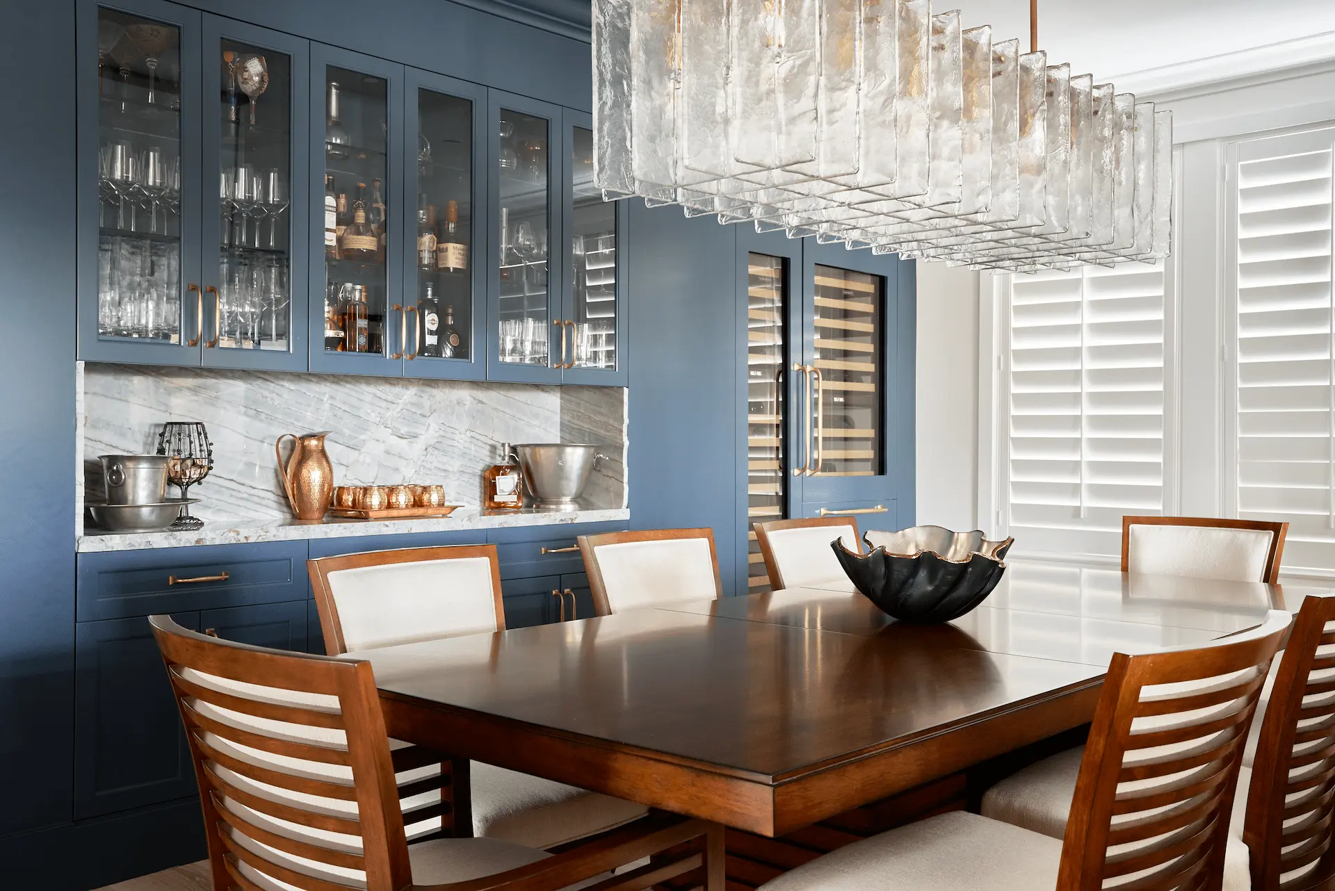 Wide shot of the dining room taken at an angle, showcasing the inviting space and contemporary coastal decor in the Ladera Ranch Remodel. Photo by Todd Huge.