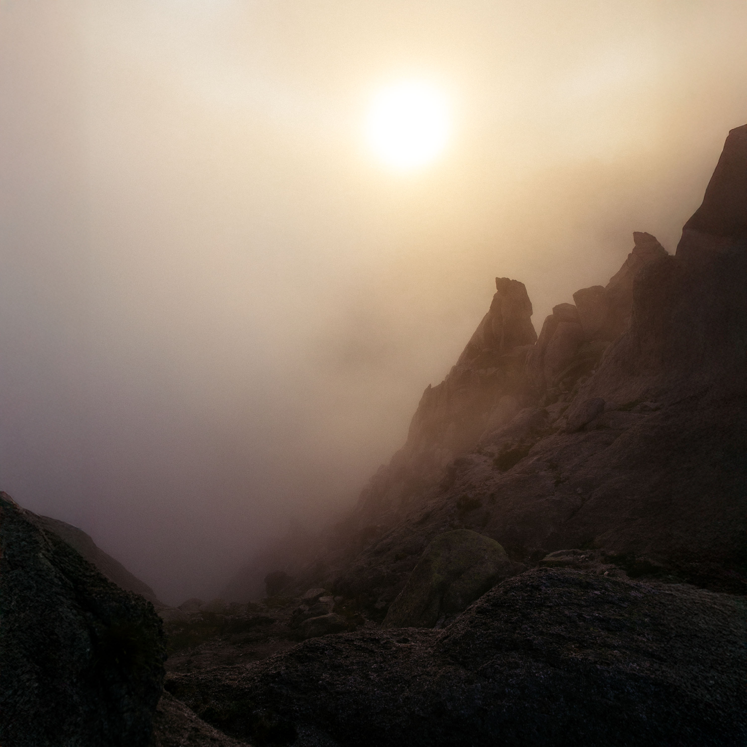 Image of dark mountain range with clouds passing through