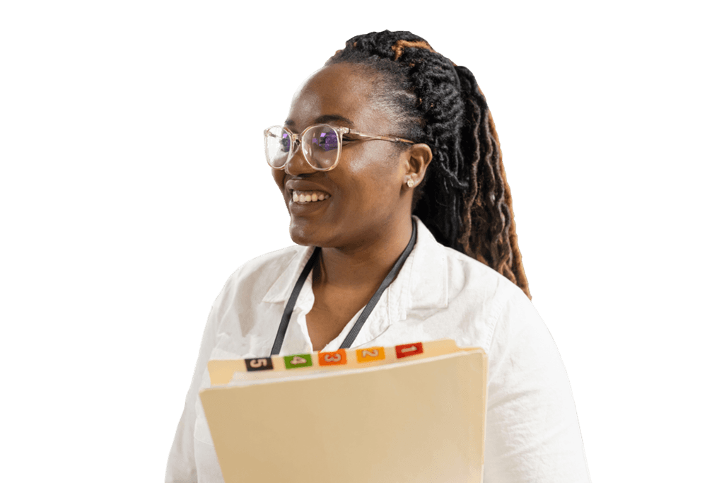 A smiling clinical staff member holding a folder of patient documents