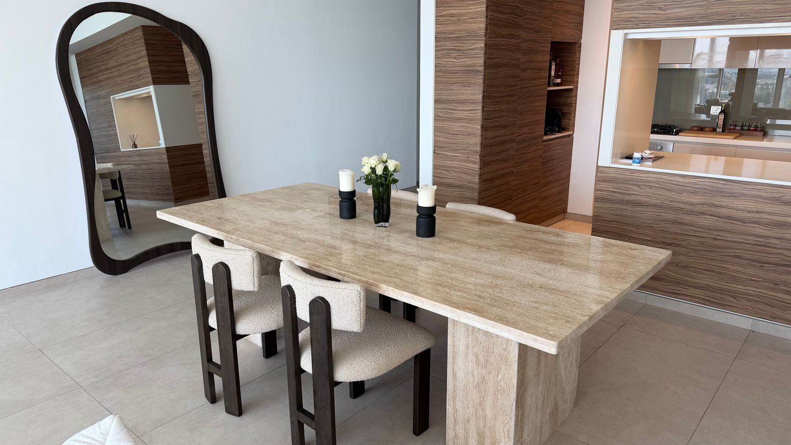 Travertine dining table and bouclé chairs by alto