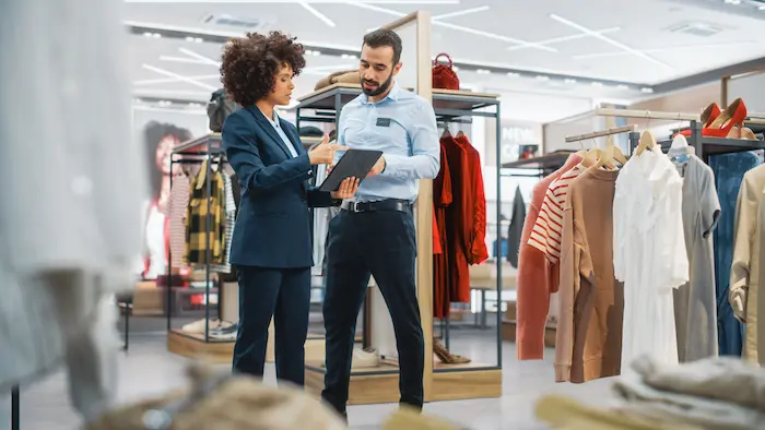 Two employees discussing the results at the retail store