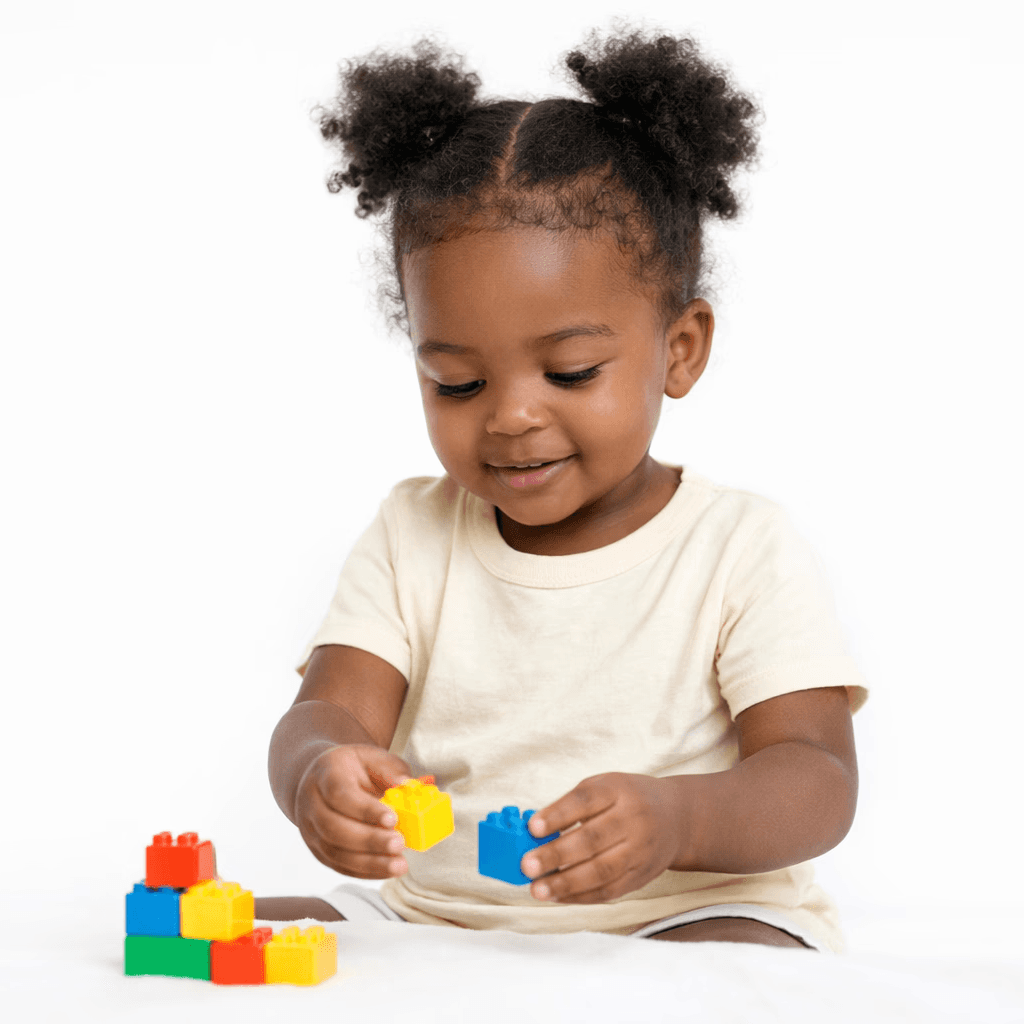 Toddler girl playing with colorful blocks in a safe childcare learning environment