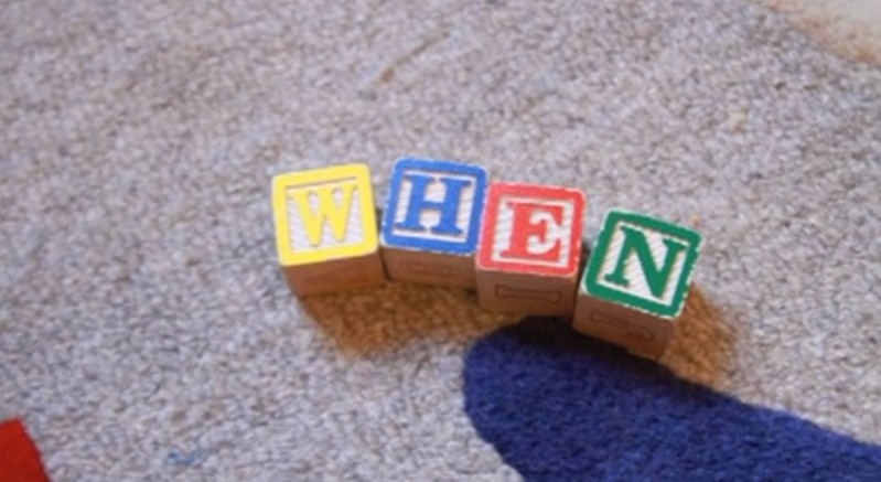wooden block cube letters on rug
