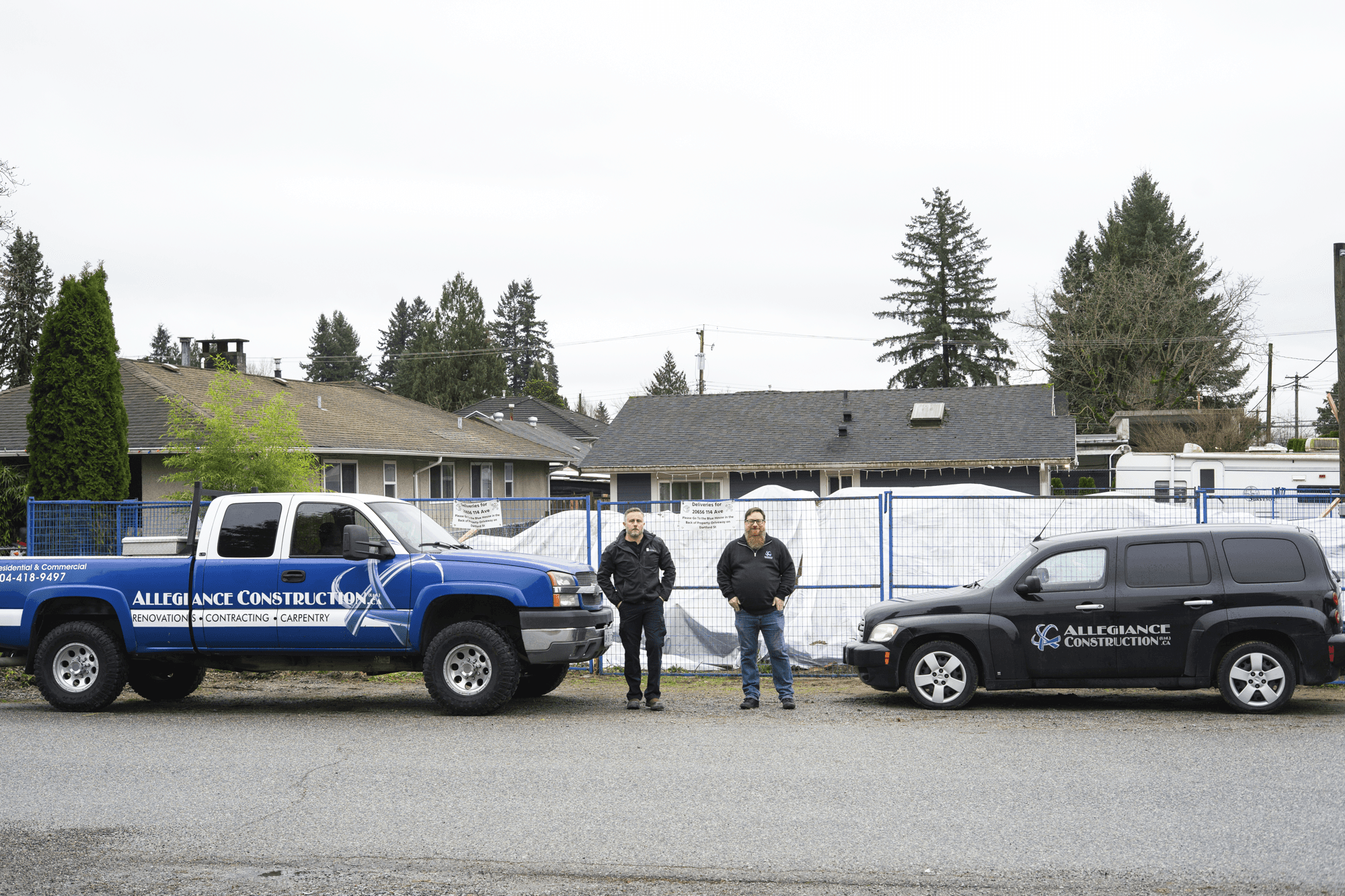 Allegiance owners standing with work vehicles