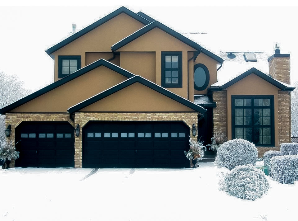 Image of Luxury home exterior with garage and snow-covered yard, showcasing KHD Homes design and construction expertise.