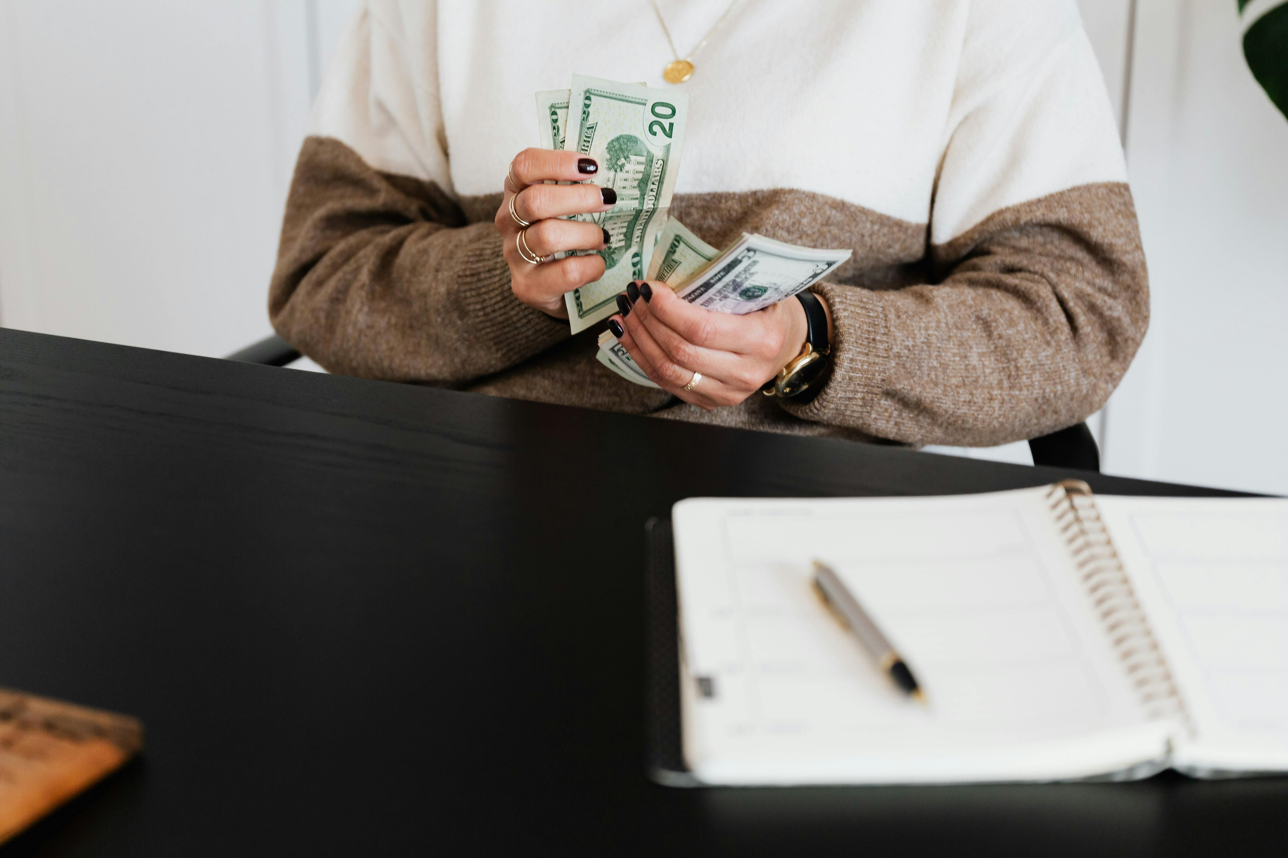 Broker in sweater countiing his money