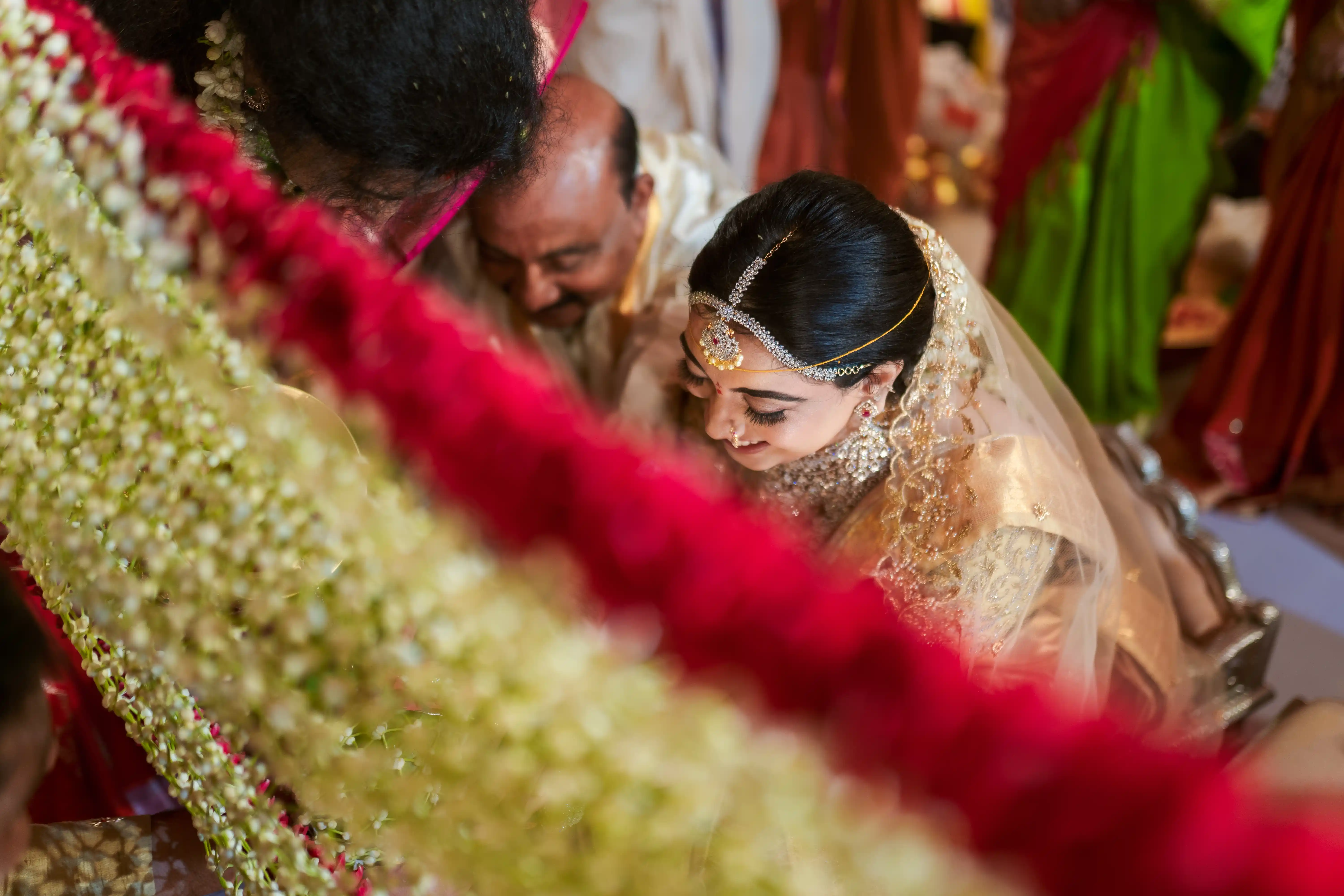 Priya, the bride, beams with joy during her wedding ceremony. Fine Art Wedding Photography in Hyderabad by Out of The Blues.