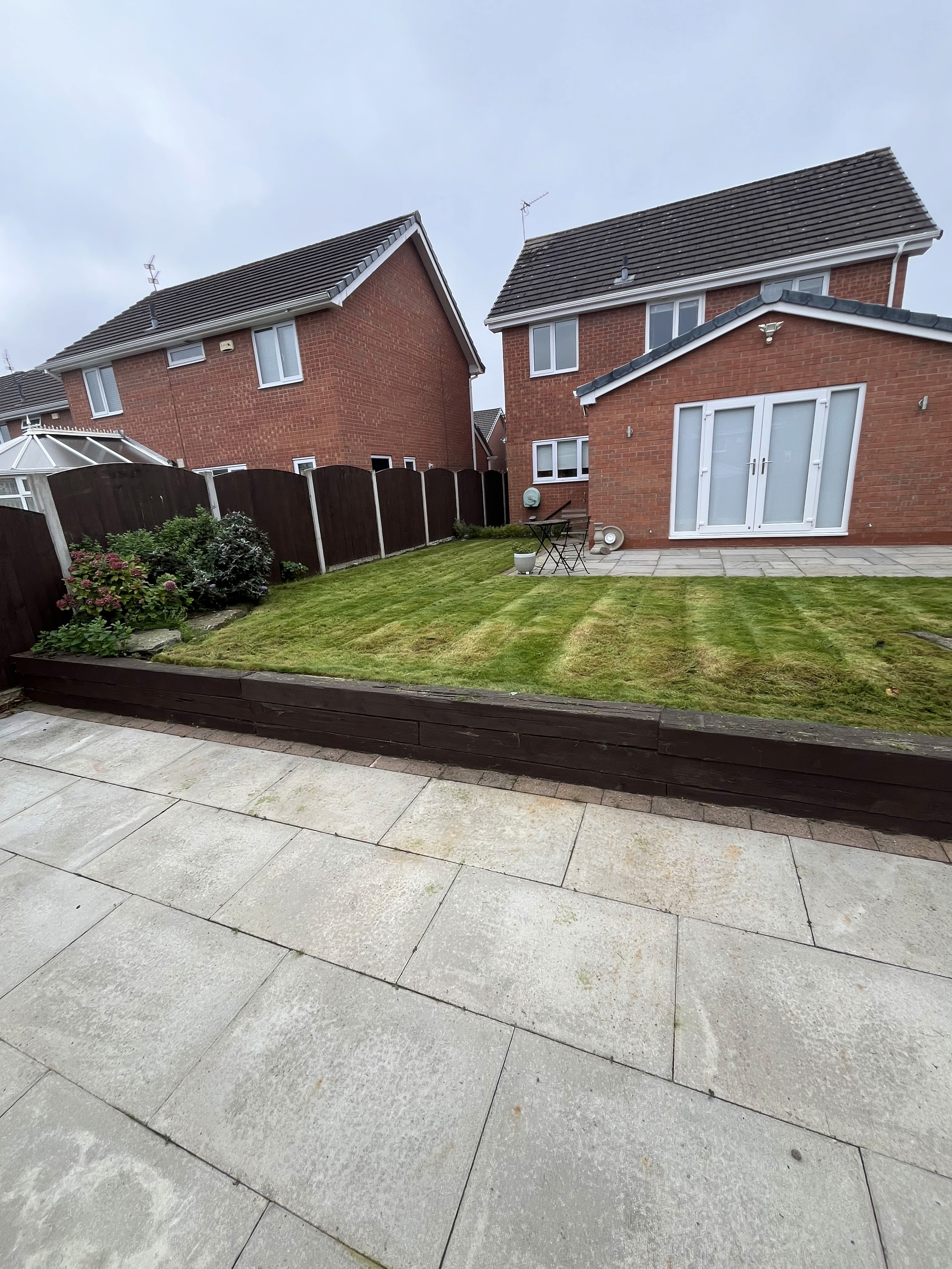 A house with a lawn and landscaping in front of it
