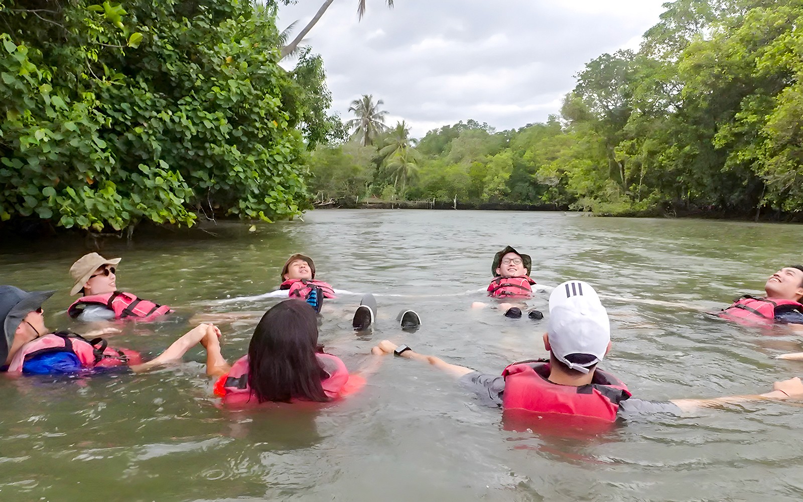 People swimming around Ketam Island on a kayaking adventure from Pulau Ubin to Ketam Island.