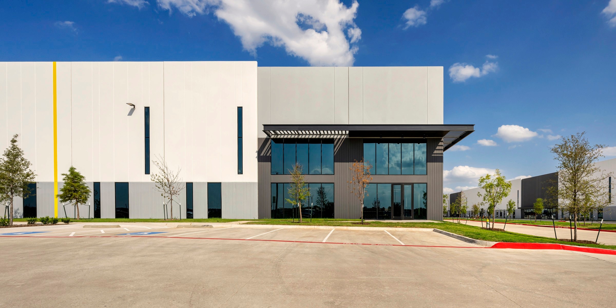 Side elevation of Mesquite 635 with its dark office block and empty parking court