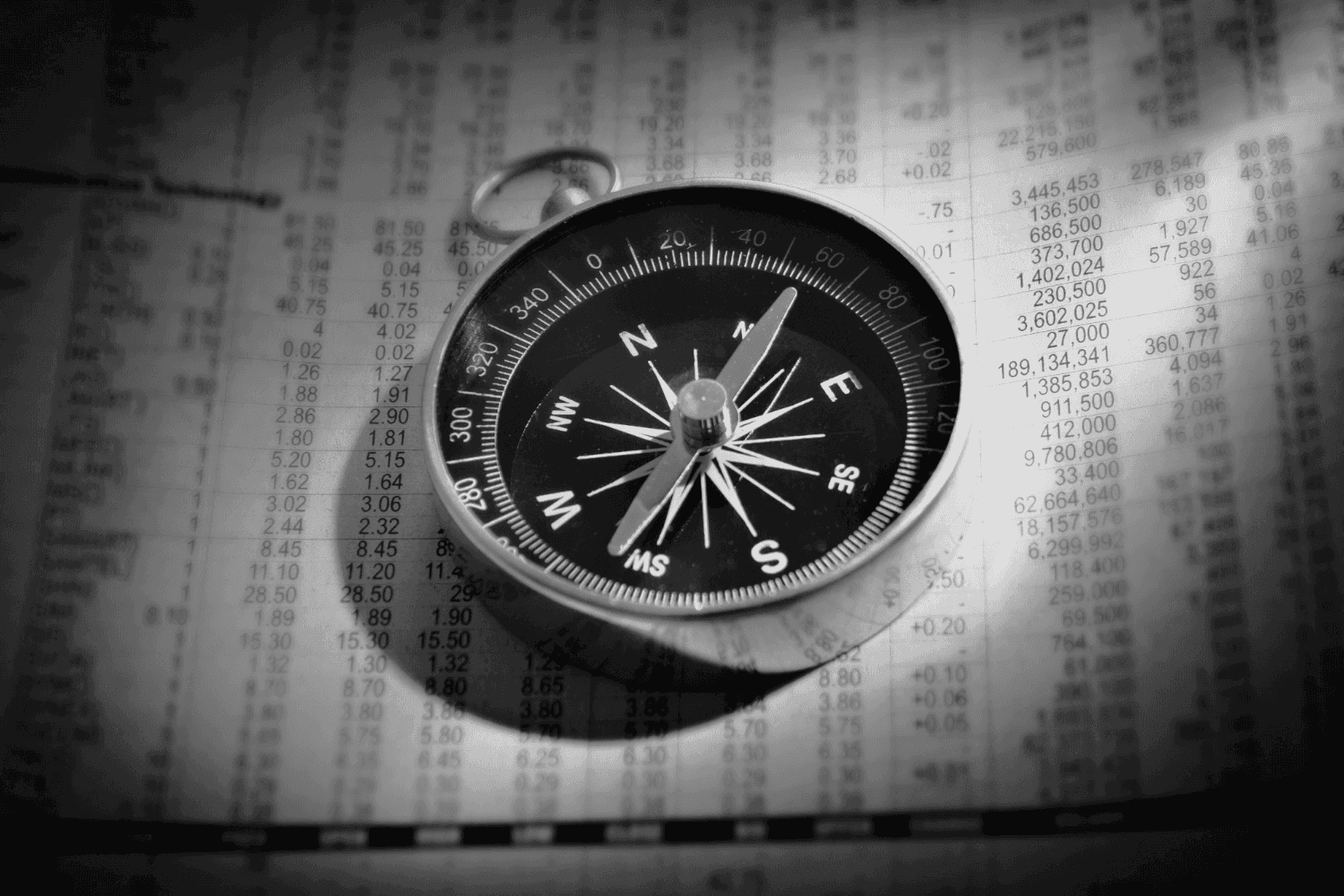 shallow focus photograph of black and gray compass