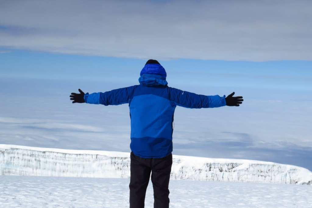 Man on the summit of Kilimanjaro