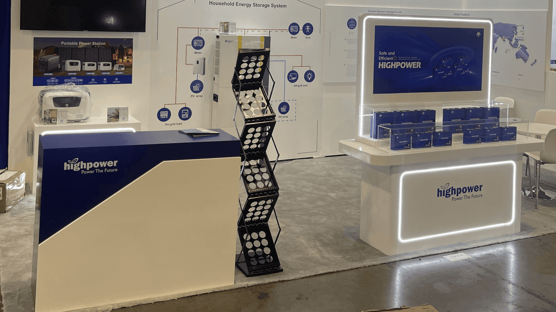 High Power RE+ 2023 10x20 renewable energy booth in Las Vegas with illuminated battery storage product counter, system graphics, and meeting area