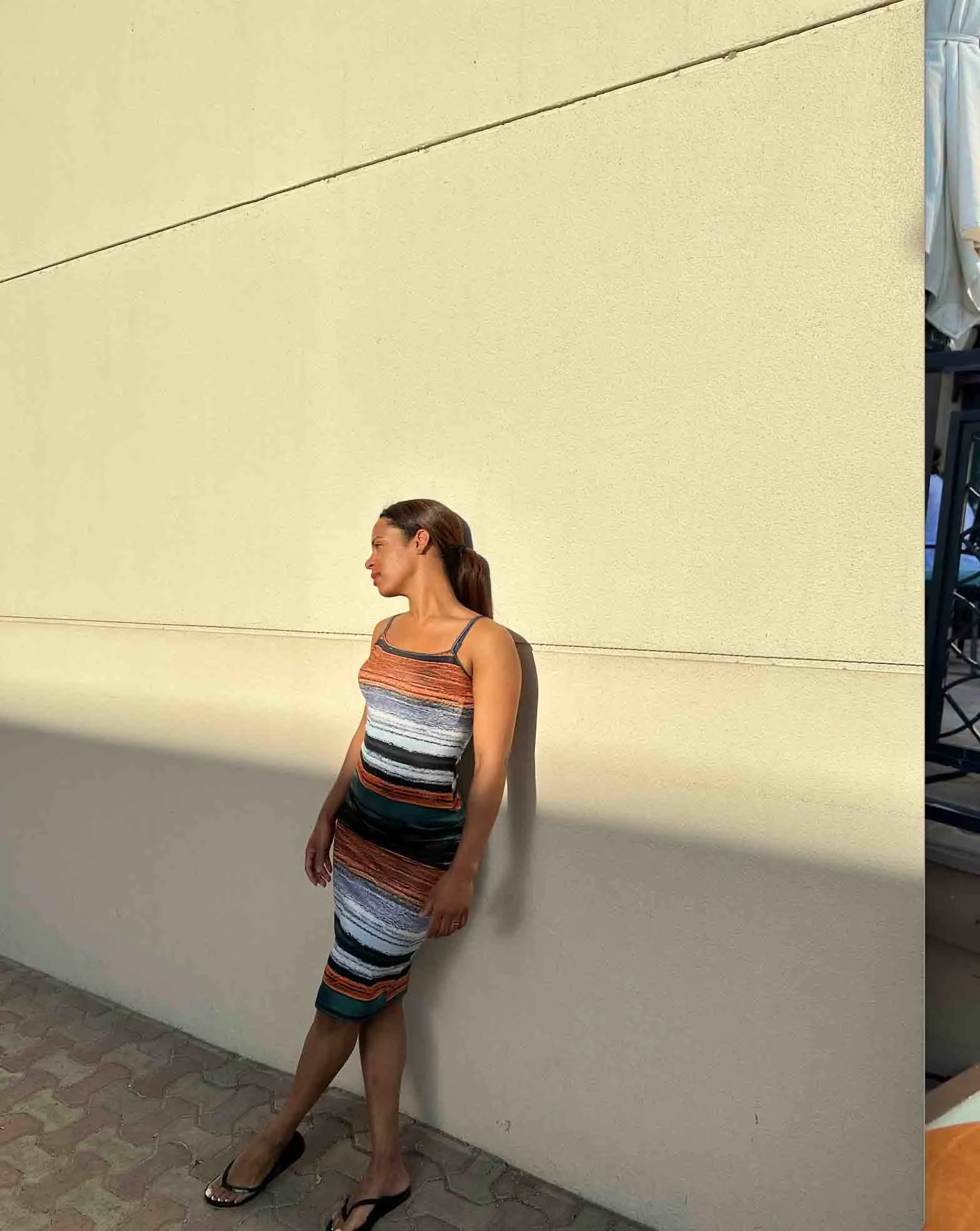 Yoania posing for a picture on a wall