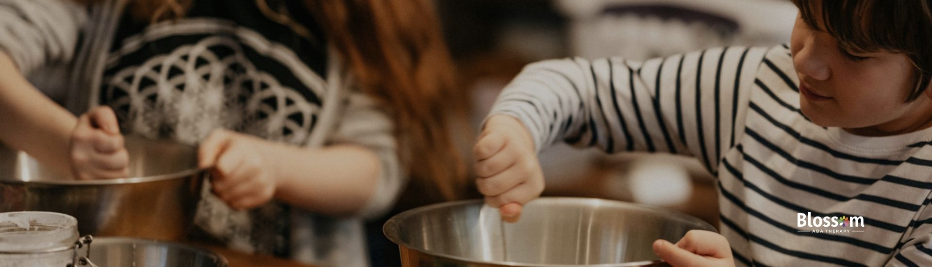 Two kids cooking together in a kitchen.