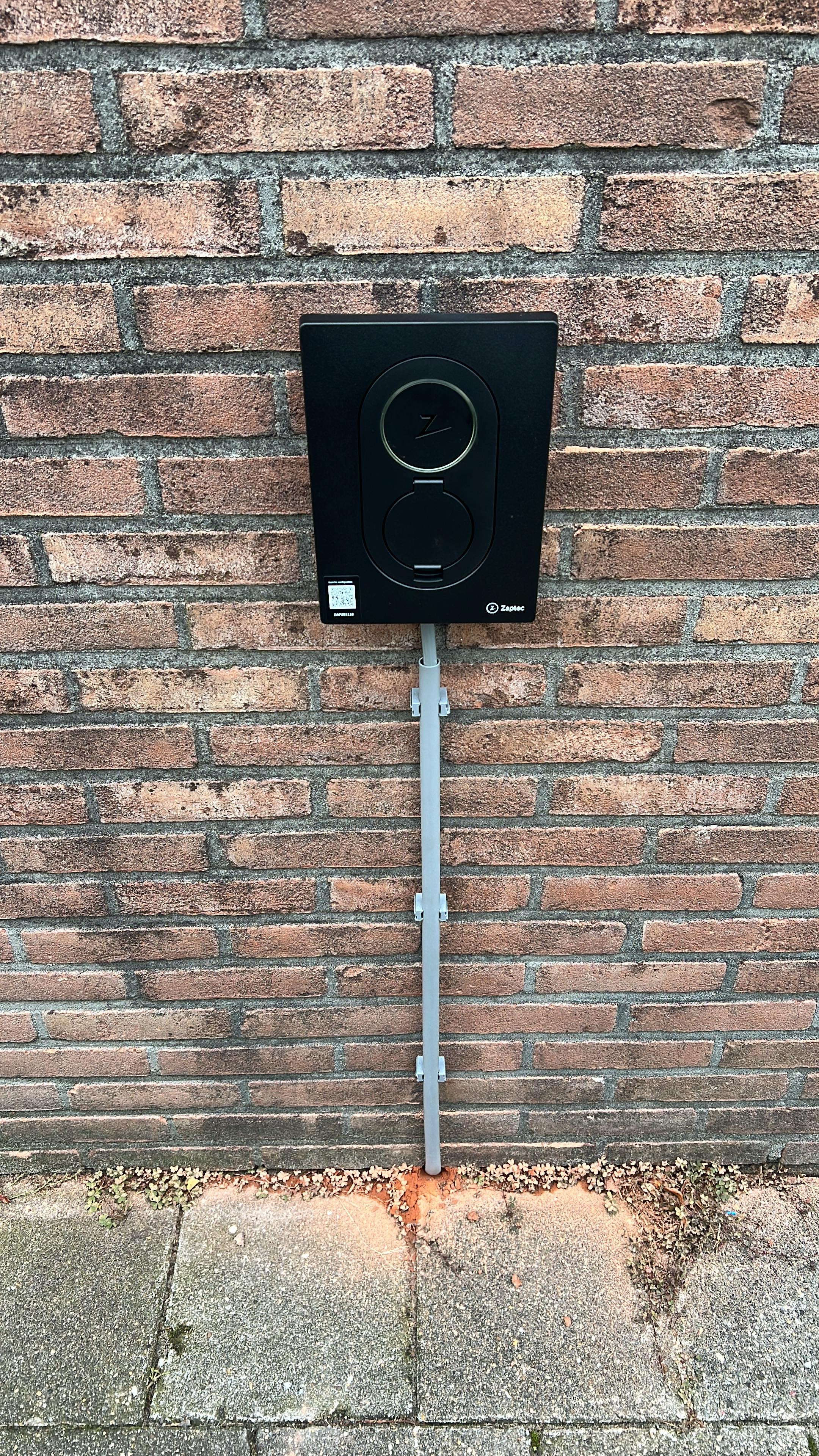 Entrance of a modern glass building with illuminated facade and reflections