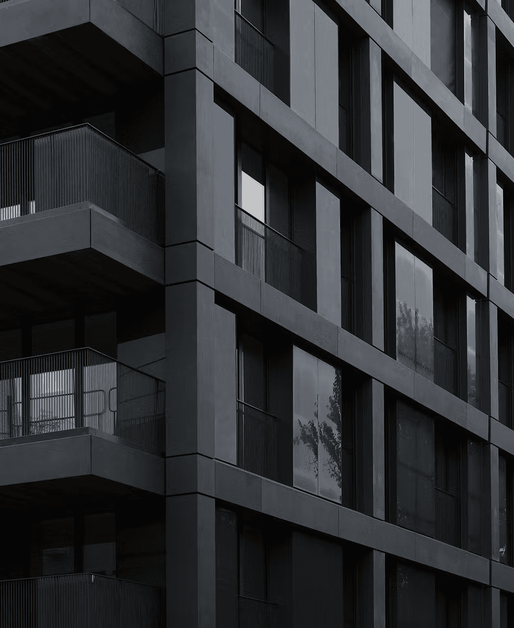 Rieder formparts concrete slats in dark tone for seamless, monolithic facade design.