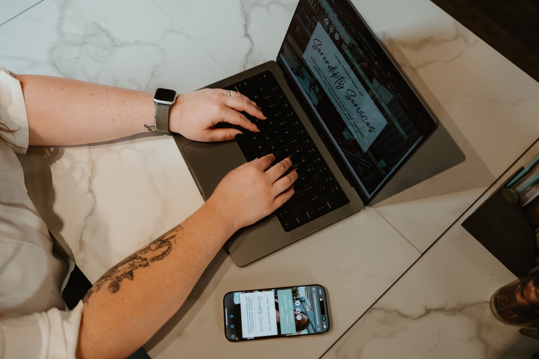 Woman typing at a laptop