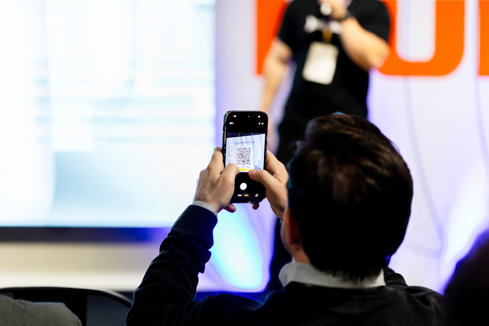man standing in front of people sitting beside table with laptop computers