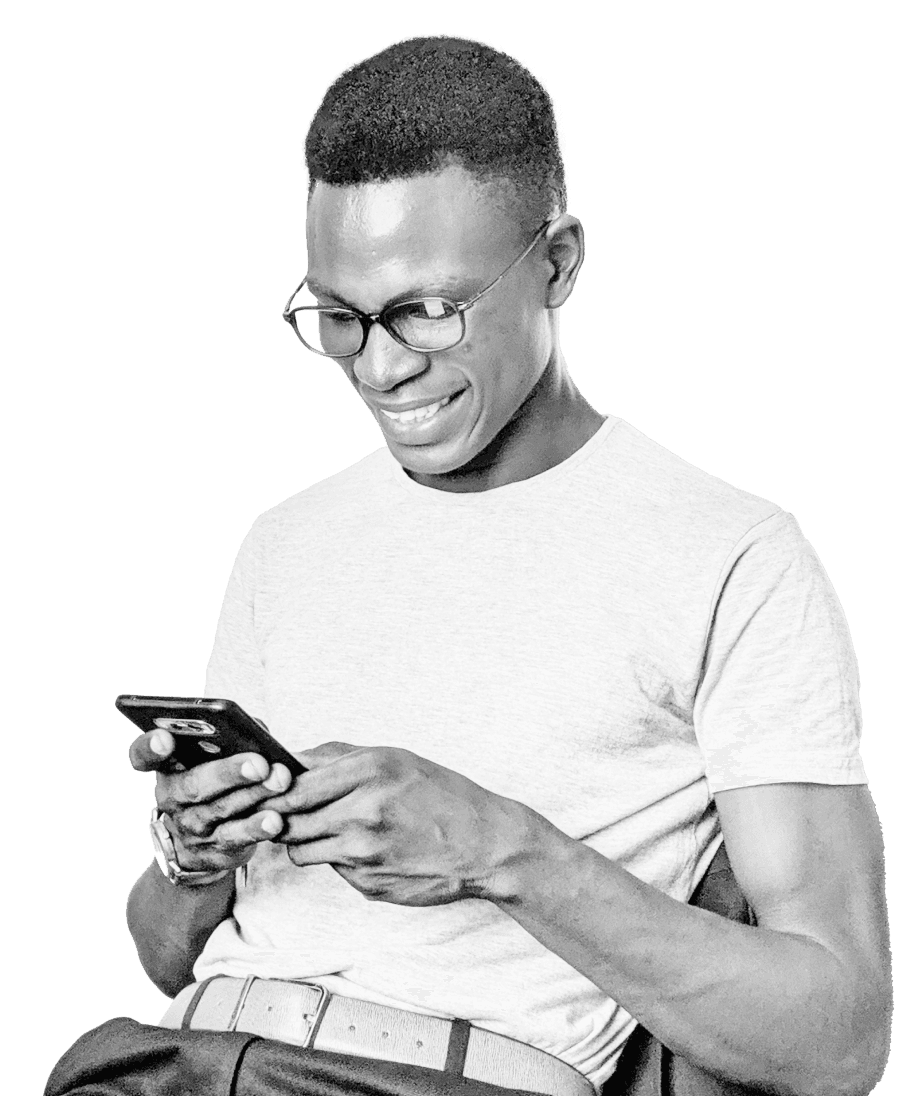 A smiling man in a white t-shirt and glasses sits and engages with his smartphone, conveying a sense of connectivity and modern engagement related to energy markets.