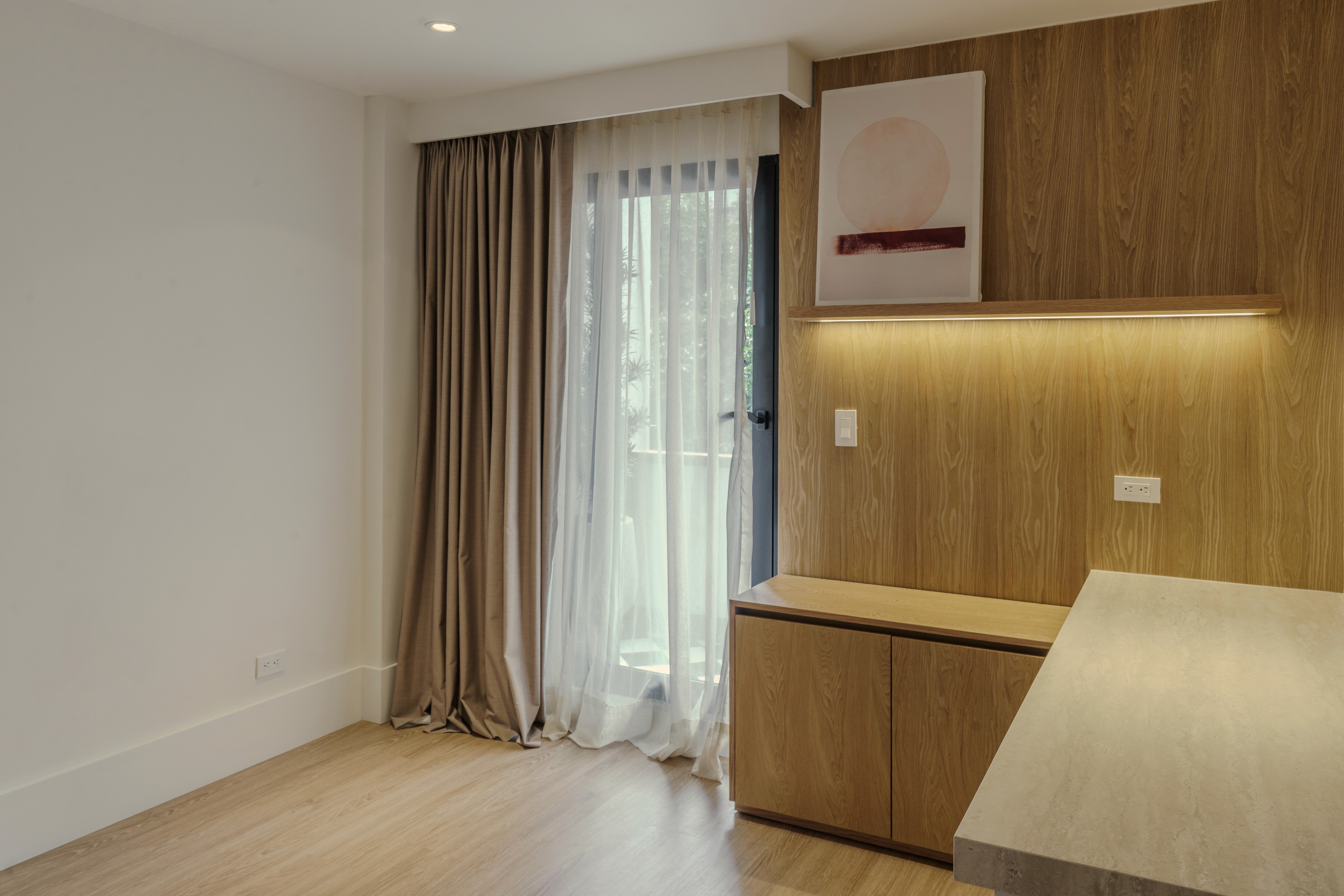 Double-height interior with flowing sculptural forms and warm raking light