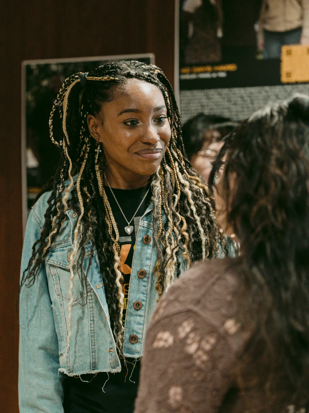 Woman smiling in conversation with a friend at Elan Church