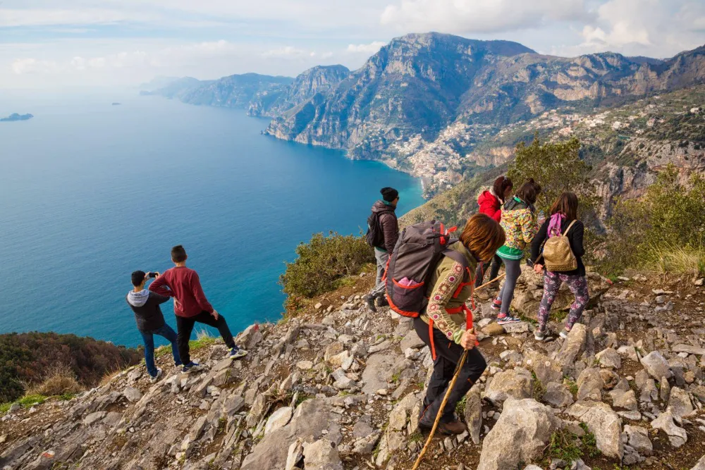 Walkers on the rocky ridge of the Path of the Gods, high above the coastline.
