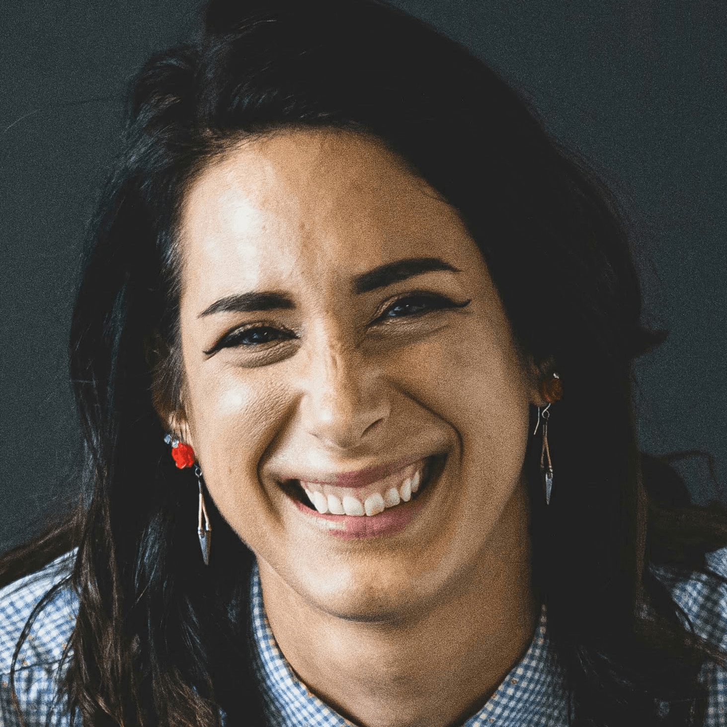 smiling woman in white and black checkered dress shirt