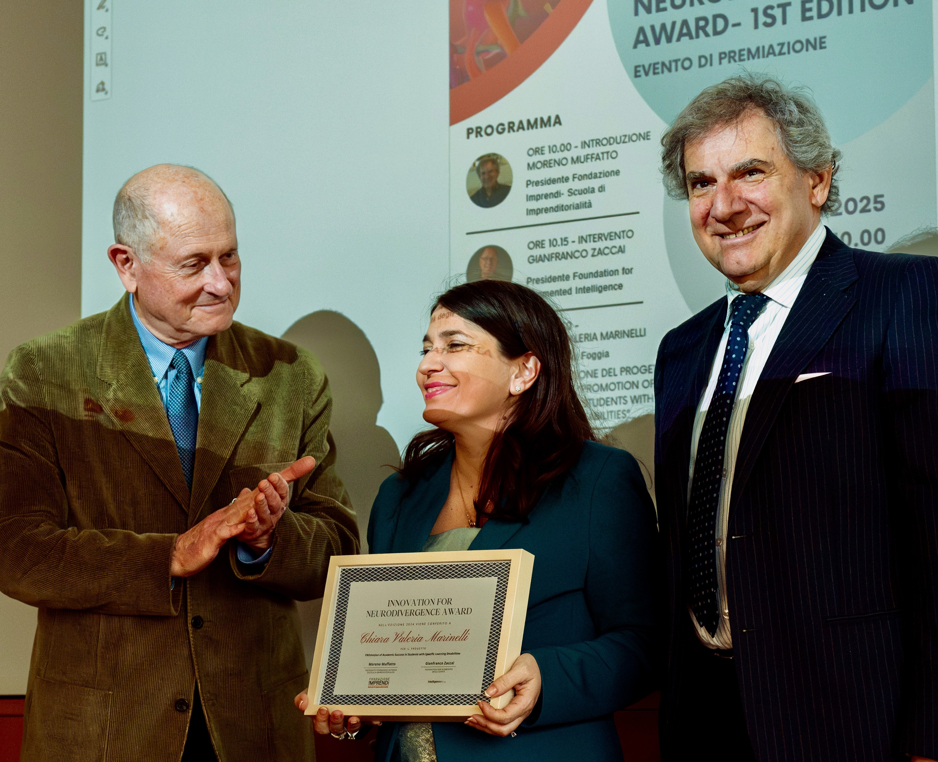 Chiara Valeria Marinelli receiving an award. Gianfranco standing next to her