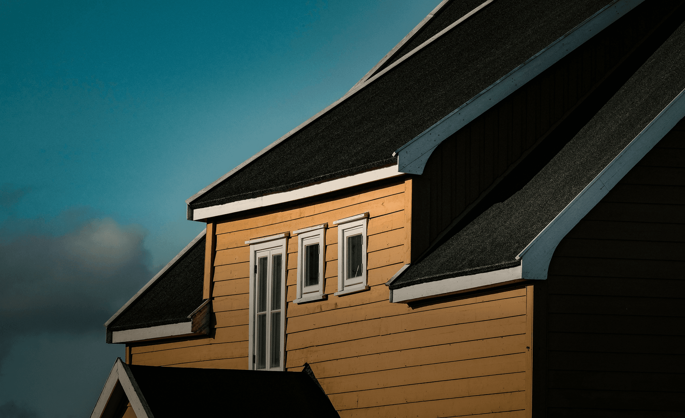 a close up of a roof with a blue sky in the background