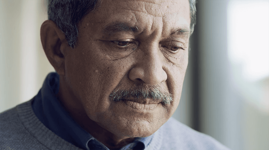 Older adult reads report with a tense, worried expression, symbolizing the anxiety many people feel when facing cognitive assessments.