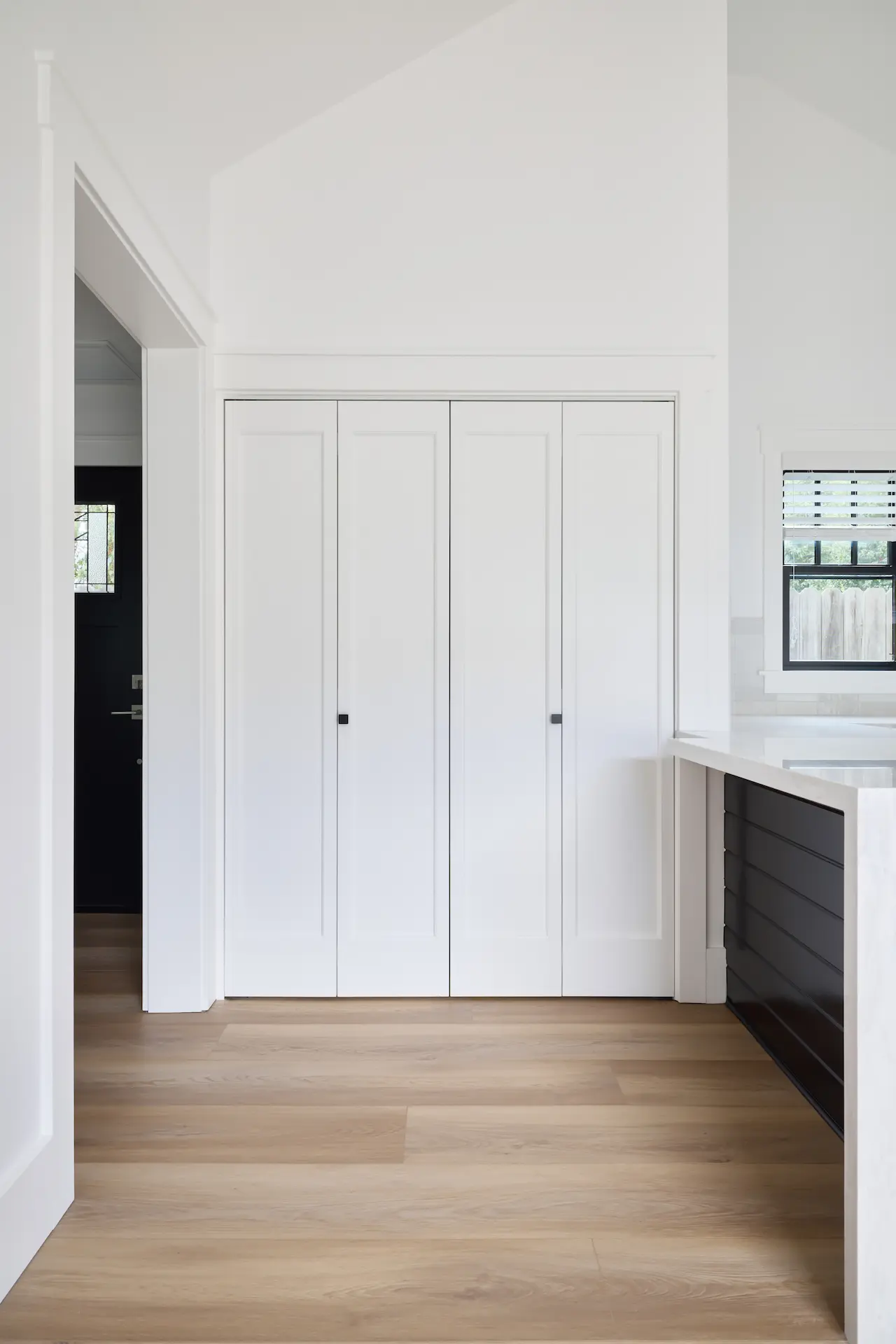 Portrait of the kitchen closet in ADU Orange, a functional and stylish element that complements the home's modern interior design. Photo by Todd Huge.