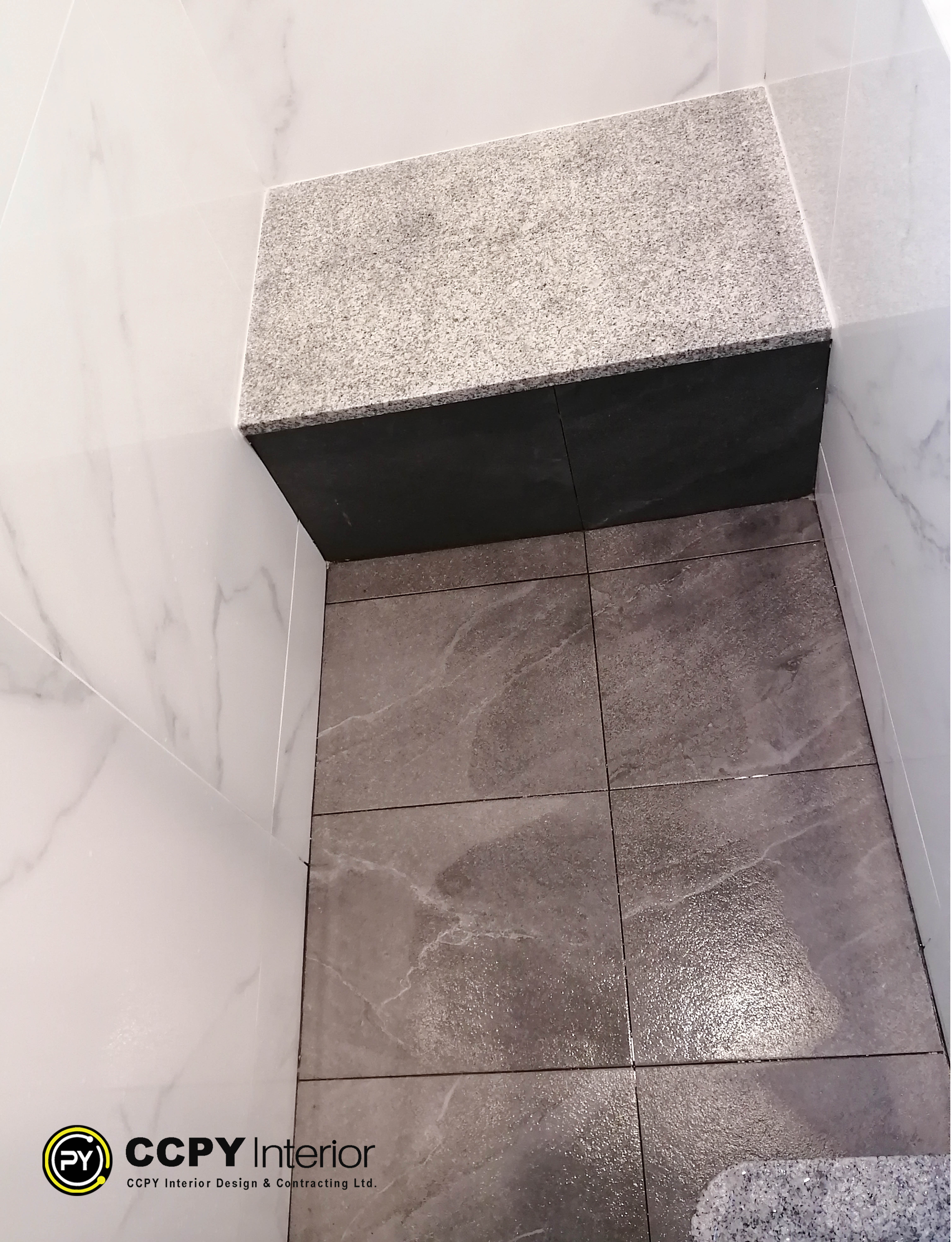 Chic foyer renovation in Mount Pavilia with classic black and white checkerboard marble flooring and a deep navy entrance door.