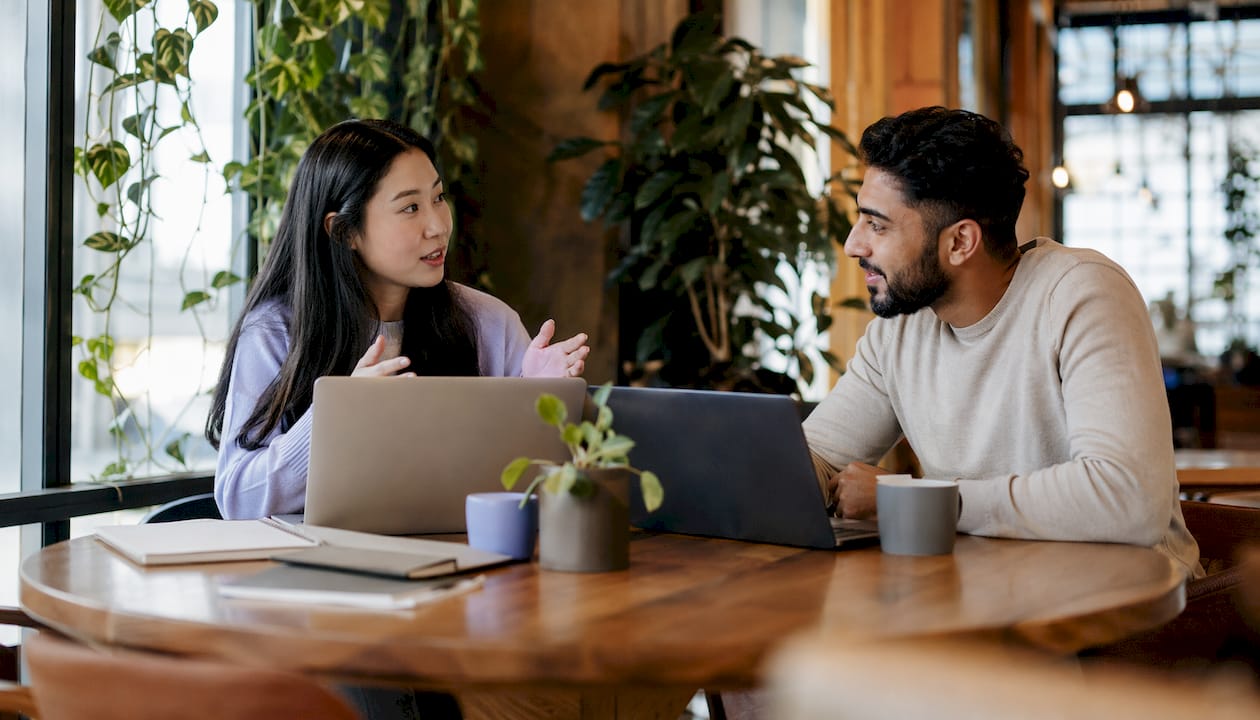 Two professionals discussing NSW web design agencies