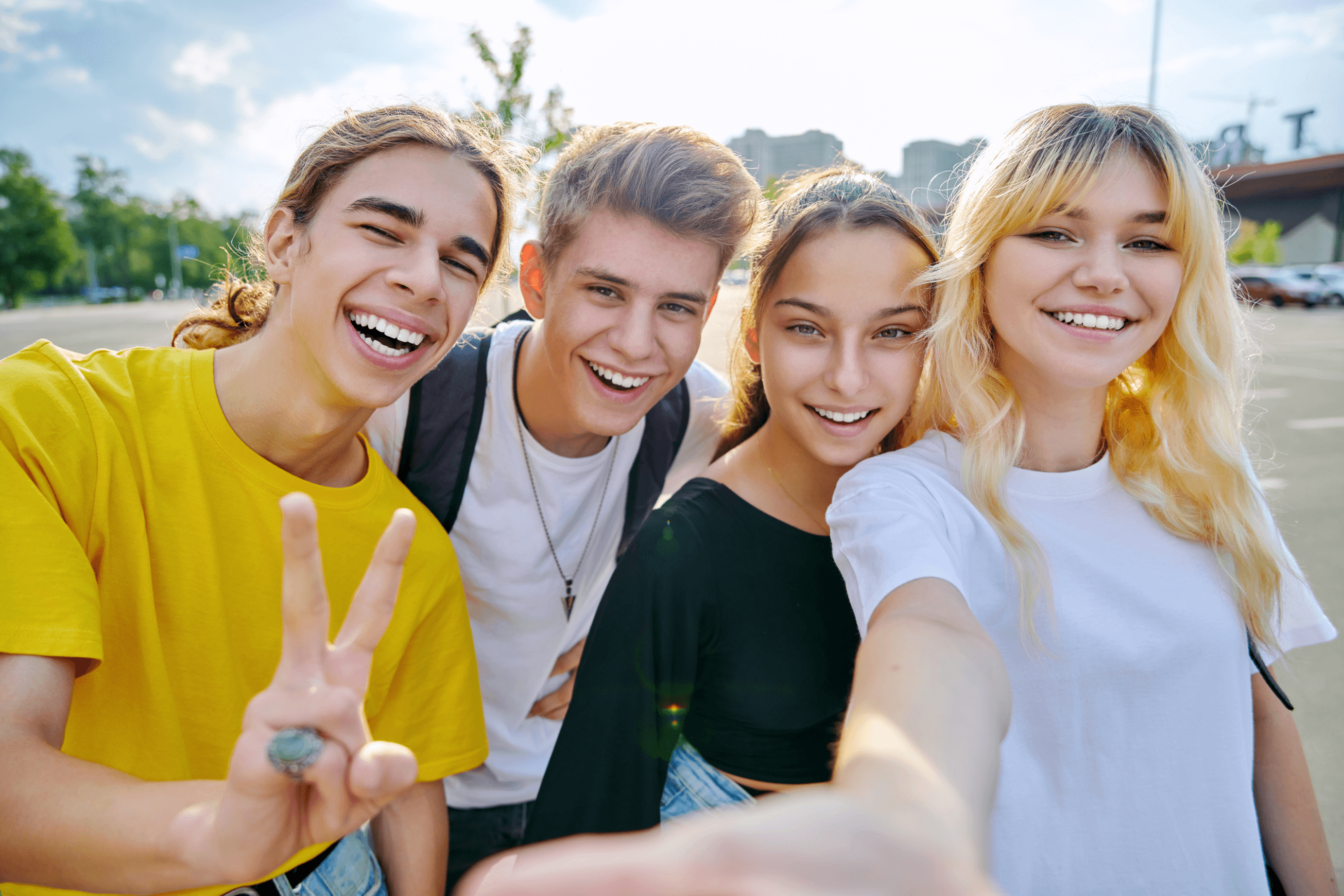 An image of a group of male and female students smiling and happy to be at school.