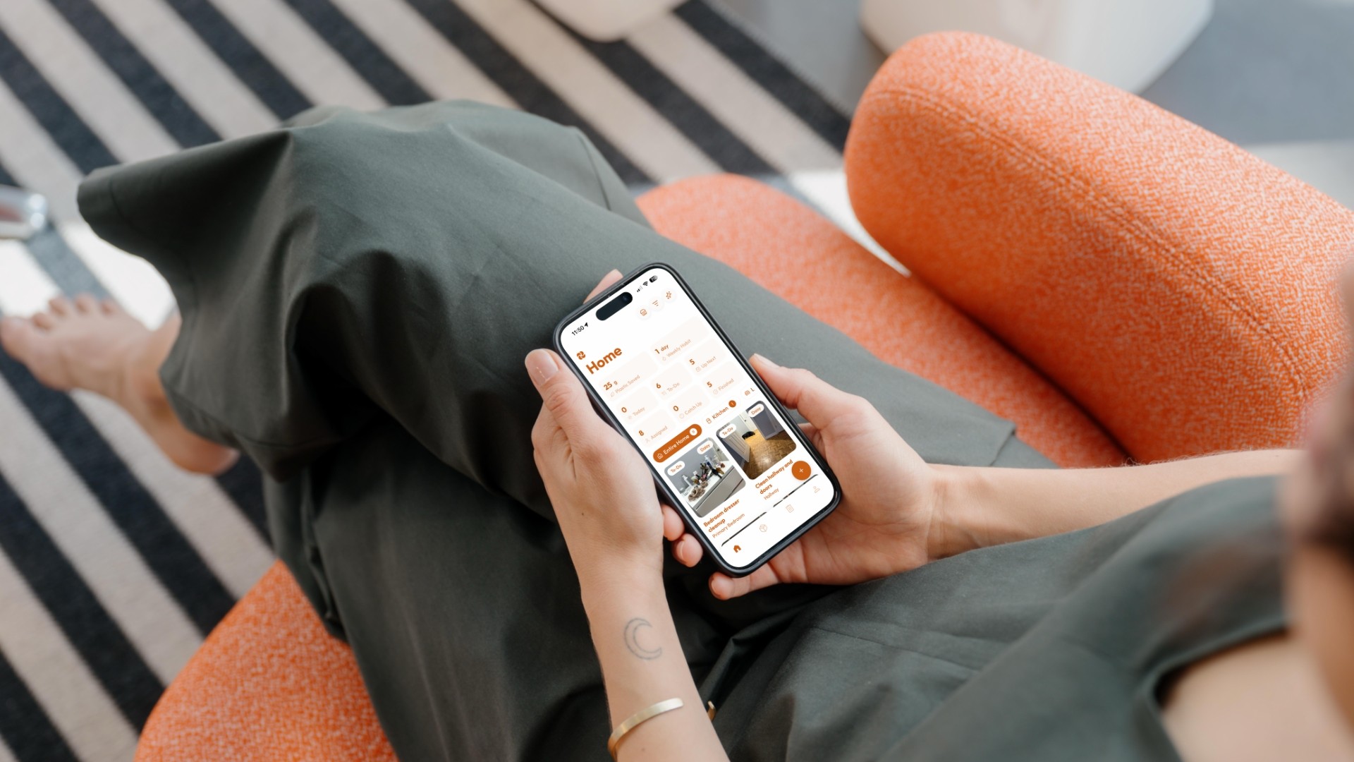 Women using a photo-based household chore app on their phone in a tidy home, a sustainable alternative to Tody.