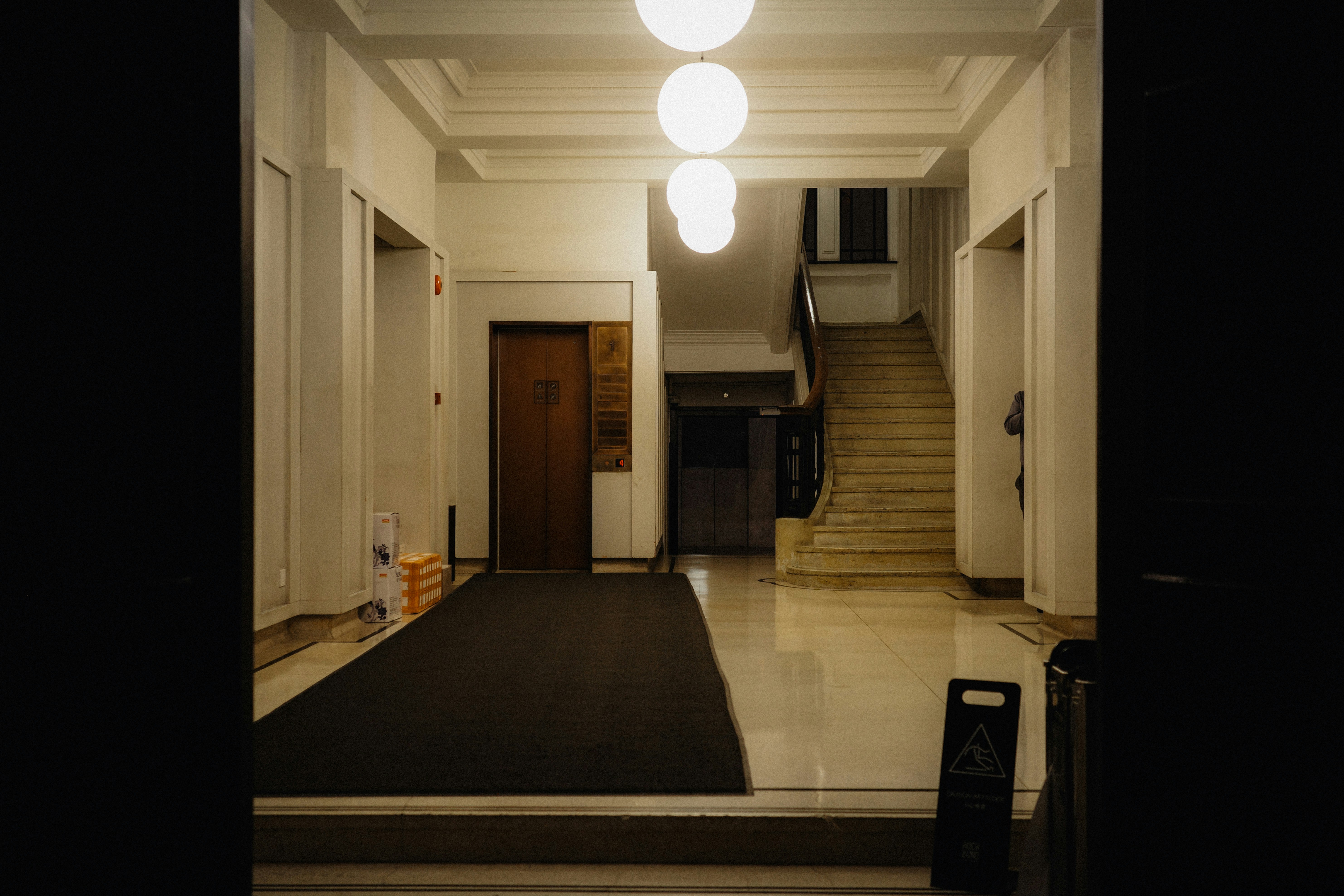 A hallway illuminated by hanging orb lights.