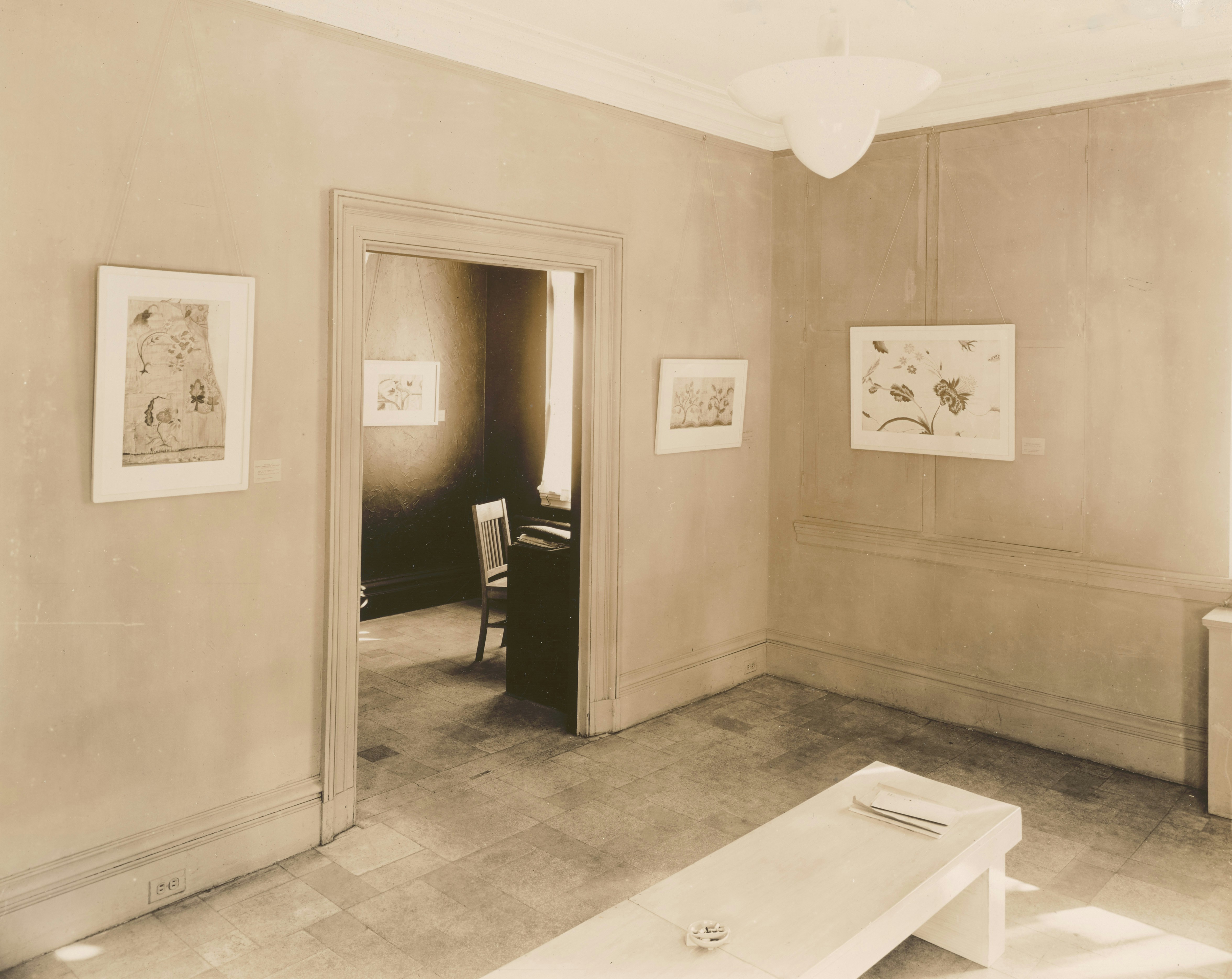 An art gallery room showcases several framed pieces.
