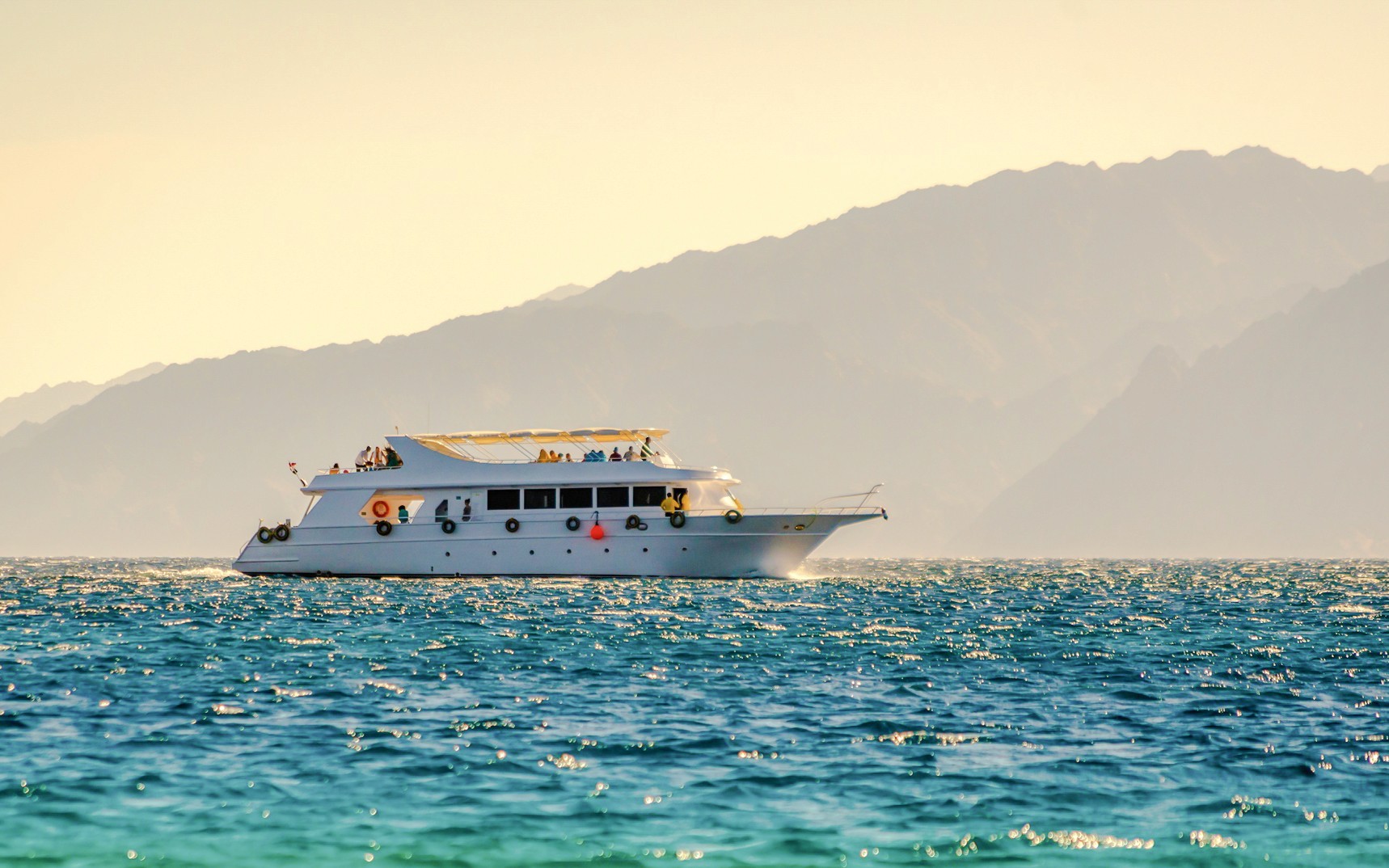 Cruise ship sailing near Tiran Island during golden hour, Sharm El Sheikh.