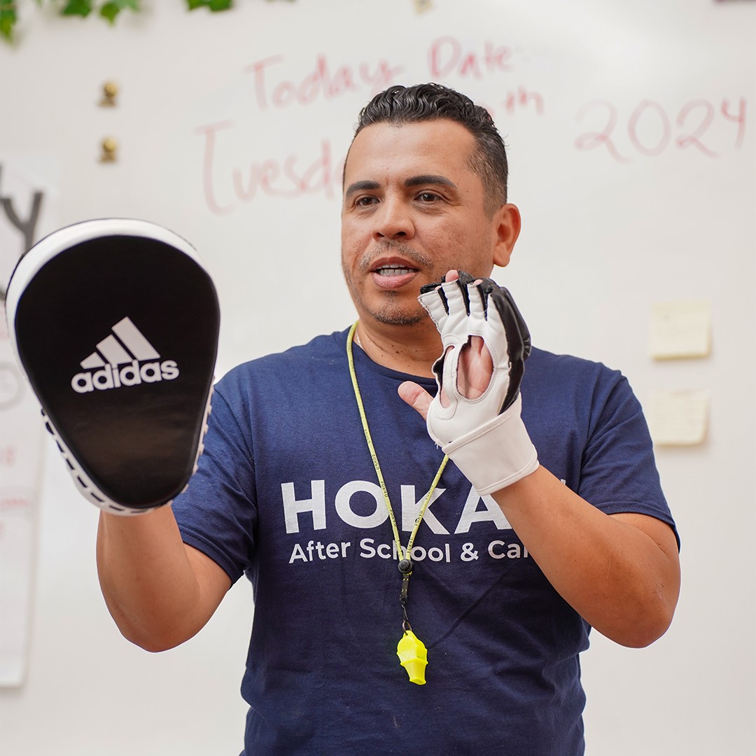 Students practicing safe takedown drills during school-based jiu-jitsu class
