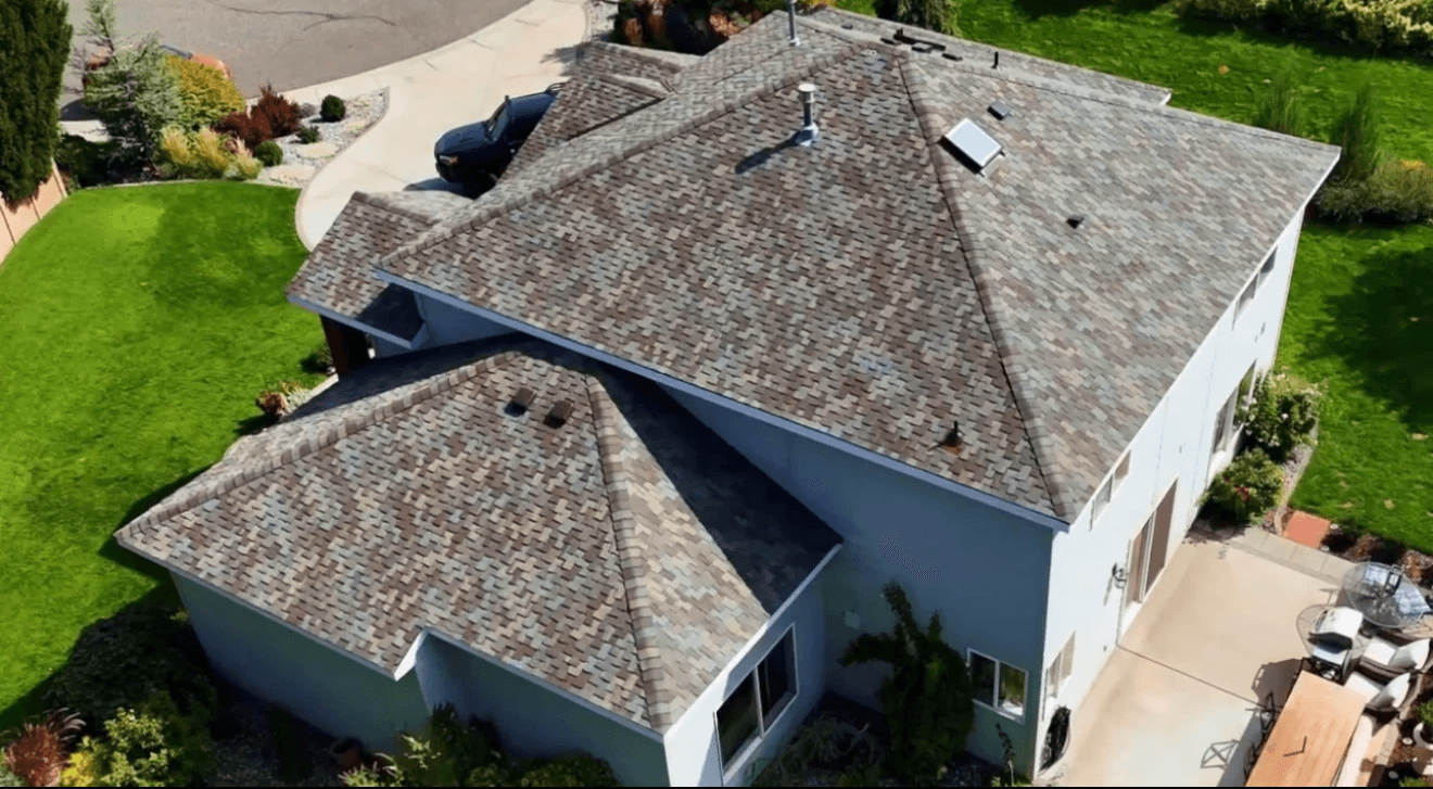 Newly installed residential roof with modern shingles designed for energy efficiency.