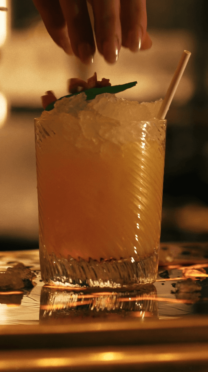 Dancer in black outfit with one leg raised behind