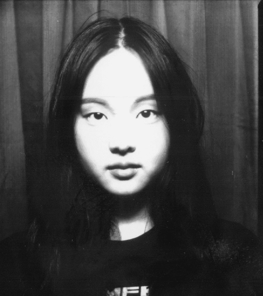 Man crouching next to a bicycle wheel.