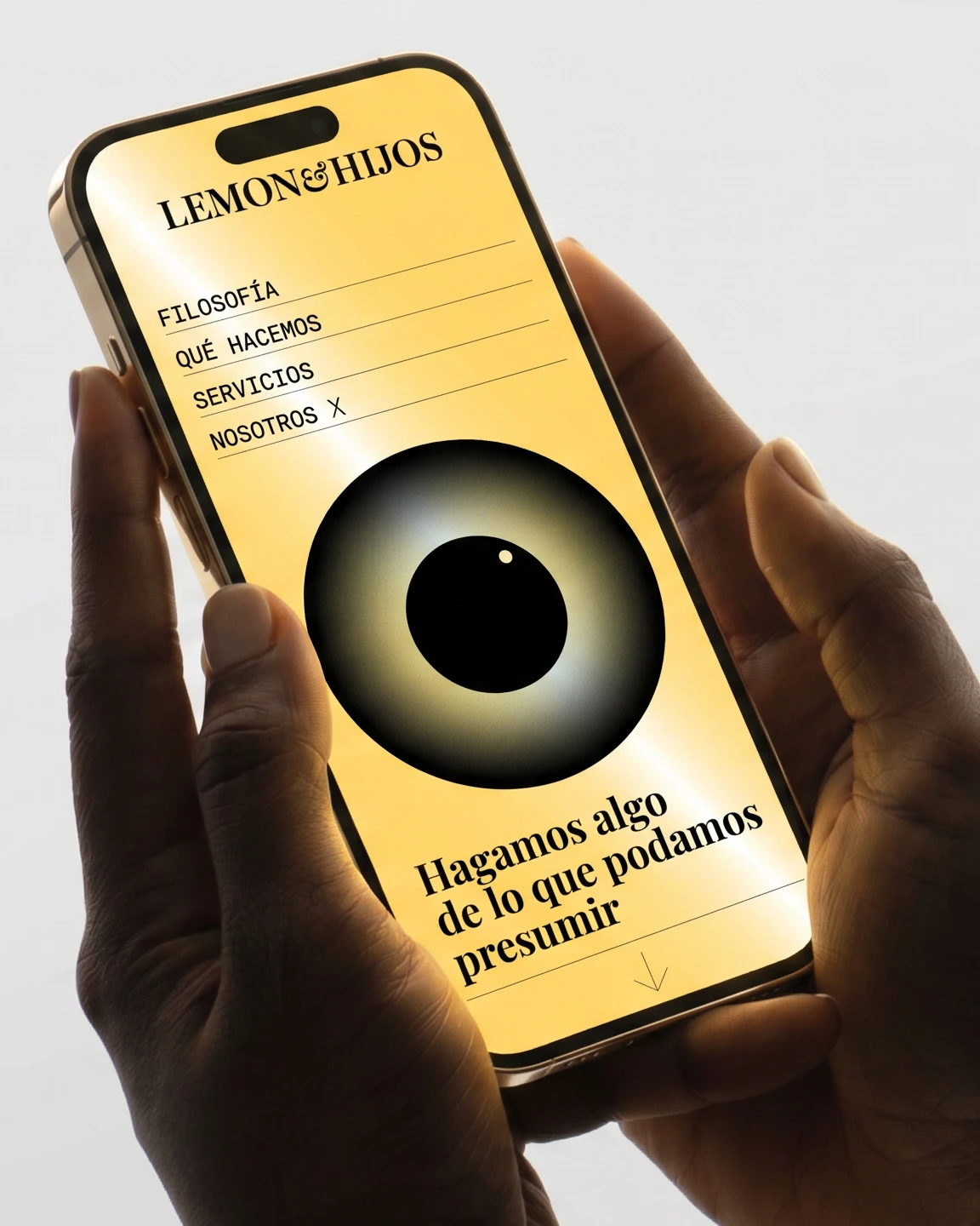 Hands holding a phone showing the Lemon & Hijos website, brand and illustration design by Sebastian Saavedra