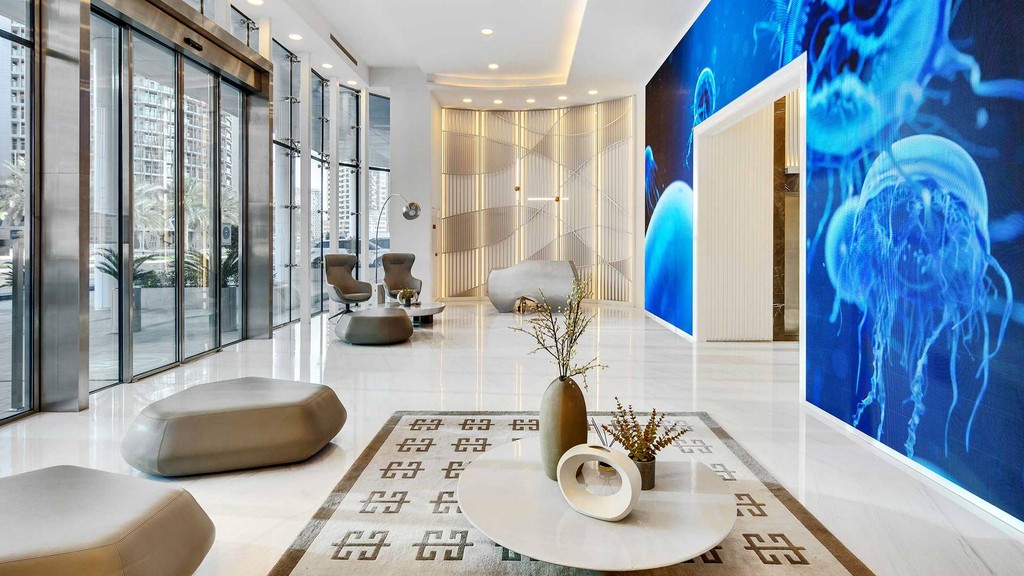 The luxurious lobby of The Pad by OMNIYAT, featuring elegant furnishings and modern design elements.