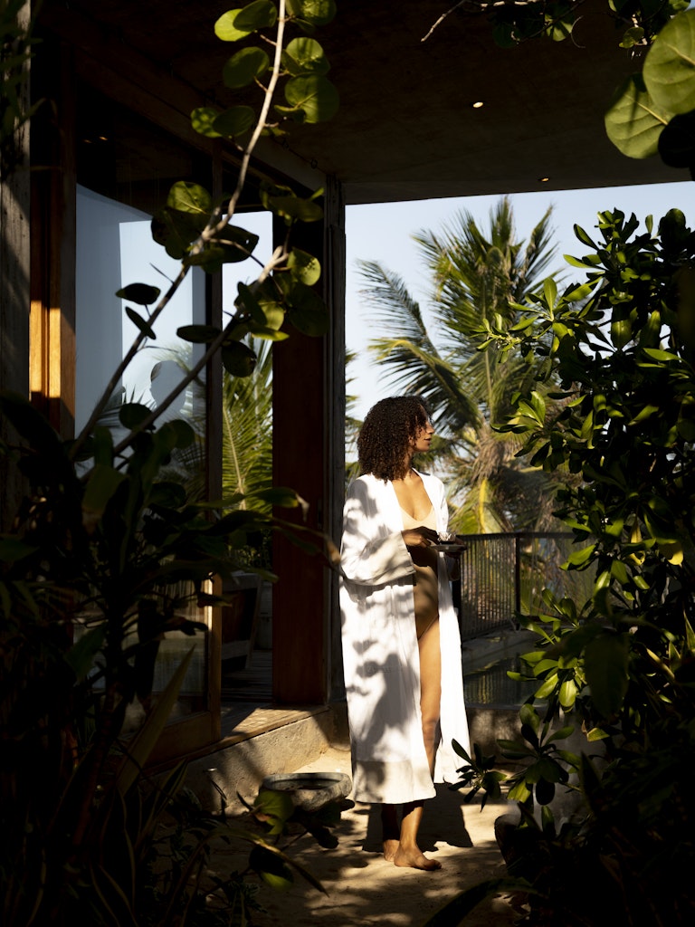 Pool area surrounded by jungle ambiance with loungers and tranquility at Be Tulum.