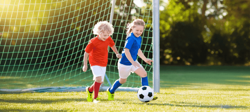 Students practicing dribbling and teamwork in a HOKALI school-based soccer enrichment program