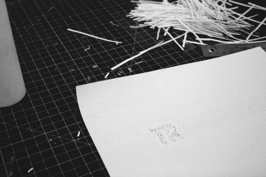 typography project made with thin pieces of paper cuts as the contour of the letters