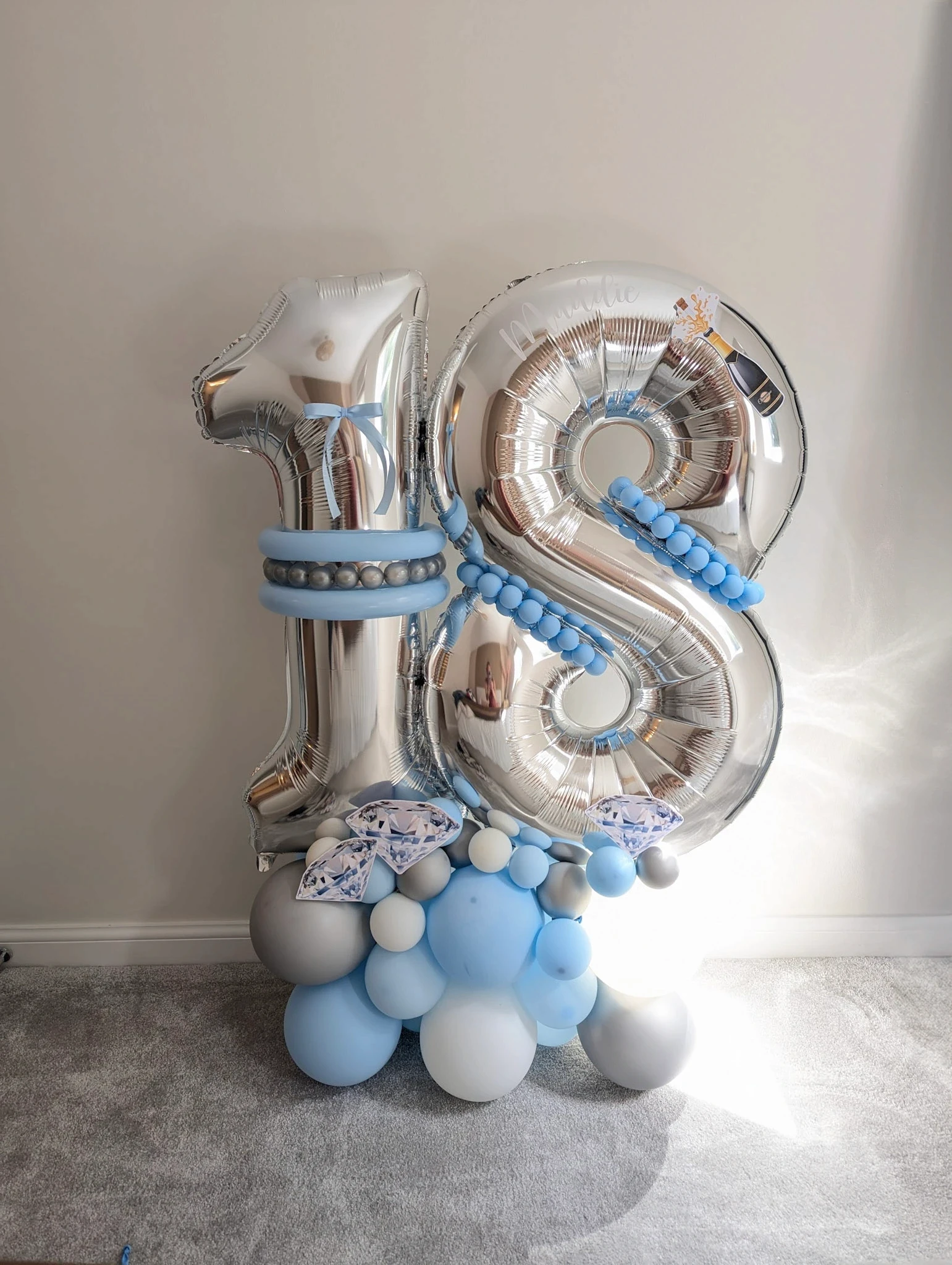Large number 18 silver balloon stack with light blue and horse-themed elements