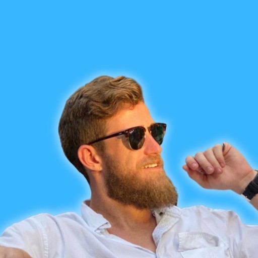 man smiling near white painted wall